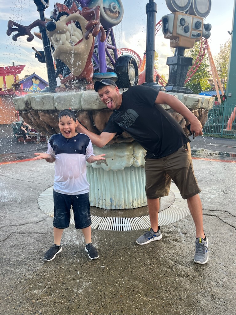 Little Brother with Big Brother at an amusement park spray park