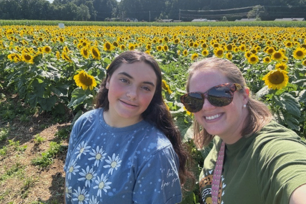 Big Sister and Little Sister selfie in a field of sunflowers